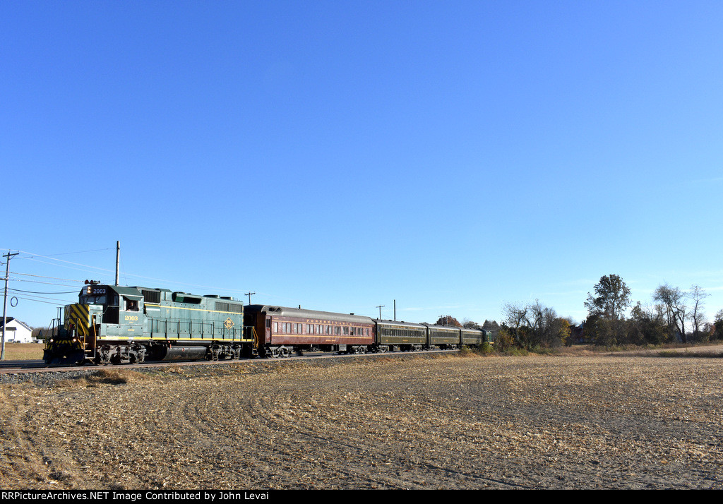 The 2003 approaches the Point Airy Road Grade Crossing with its train